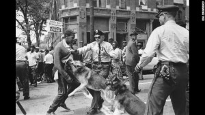 A 17-year-old civil rights demonstrator, defying an anti-parade ordinance of Birmingham, Ala., is attacked by a police dog on May 3, 1963. On the afternoon of May 4, 1963, during a meeting at the White House with members of a political group, President Kennedy discussed this photo, which had appeared on the front page of that day's New York Times. (AP Photo/Bill Hudson)